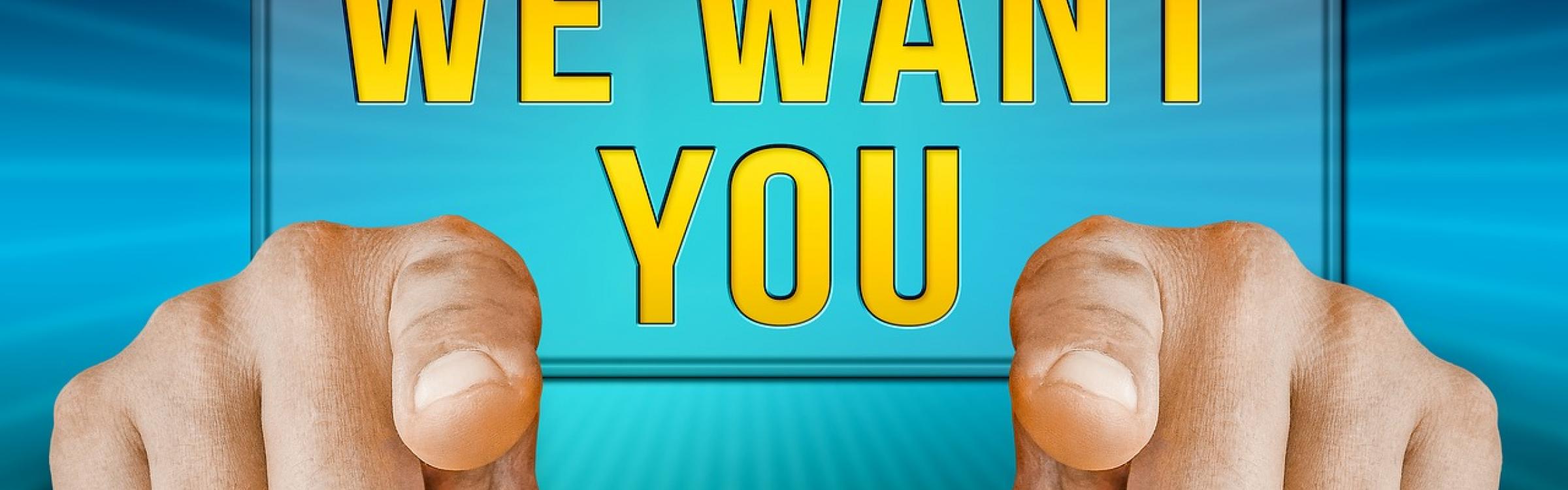 Een affiche voor een vacature met twee handen die wijzen en met de zin op 'We want you'.