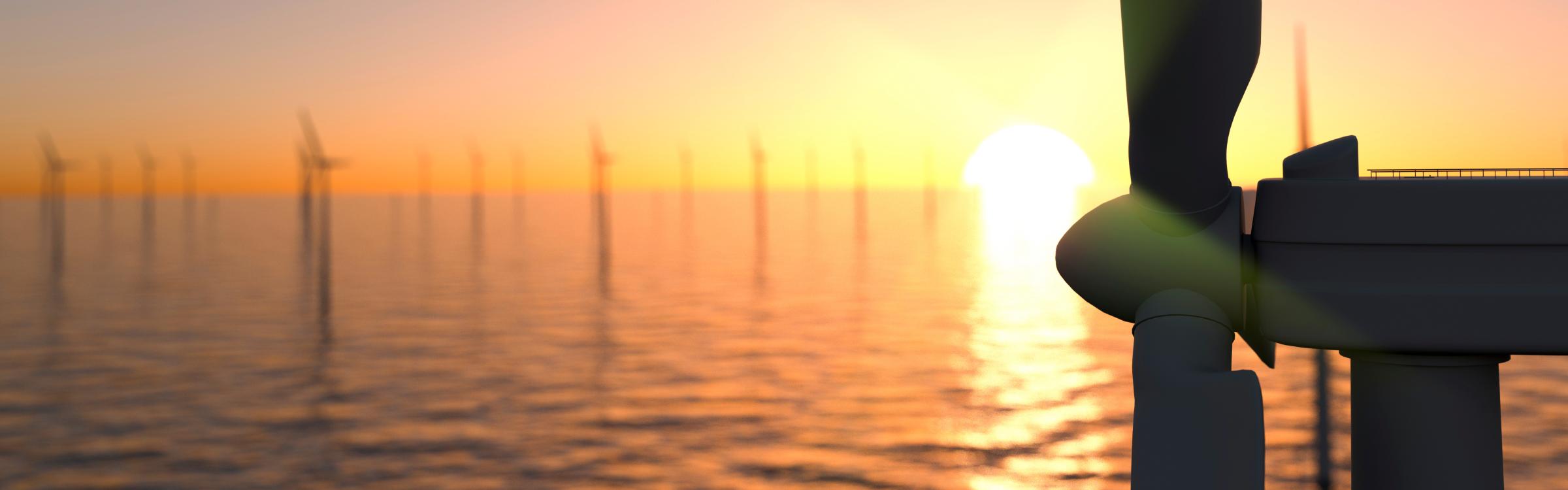 Windmolens op zee met op de achtergrond een ondergaande zon.