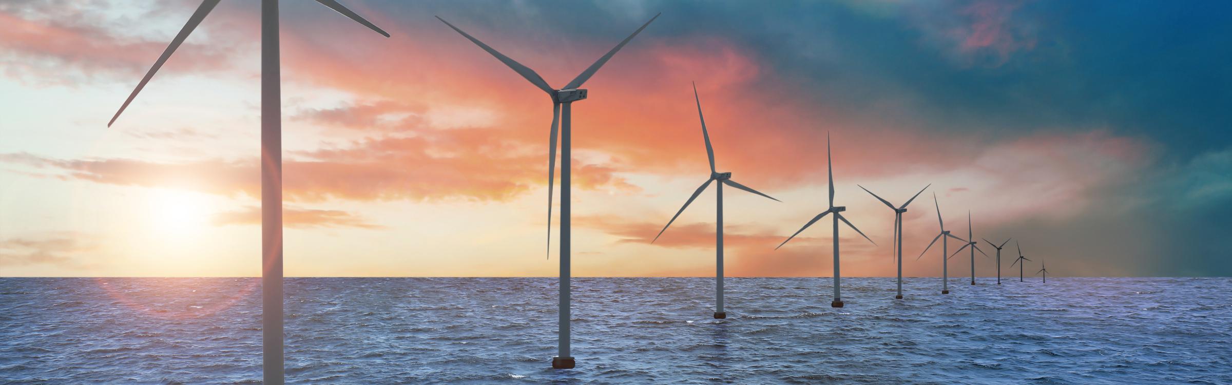 Windmolens die draaien in het midden van de zee.