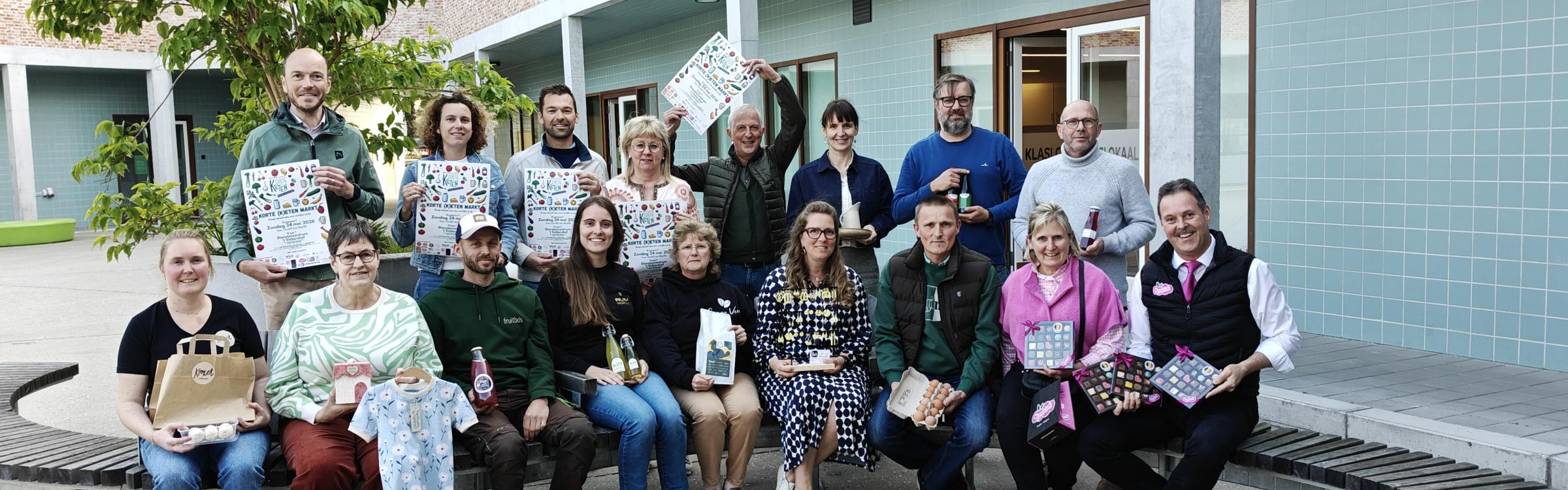 Groepsfoto van leden college van burgemeester en schepenen, en organisatoren en deelnemende handelaars van de korte keten markt